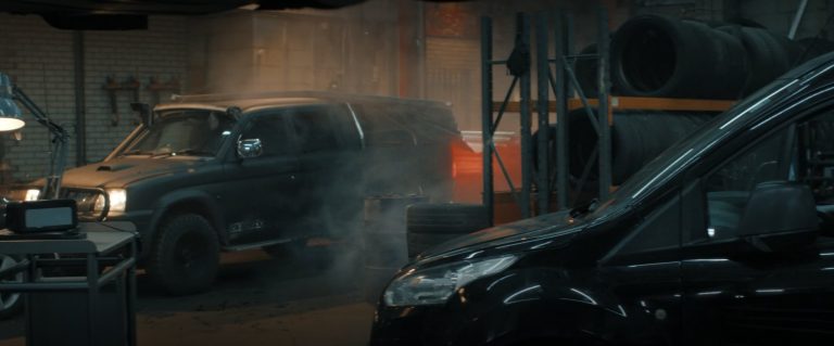 The Storm Edition with its headlights on in the smoke