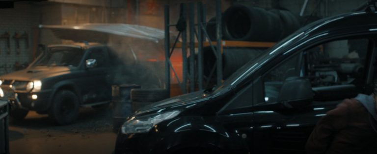 The Storm Edition behind a black van in the garage