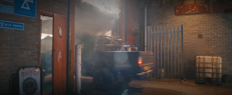 The Storm Edition driving through the garage door in the smoke