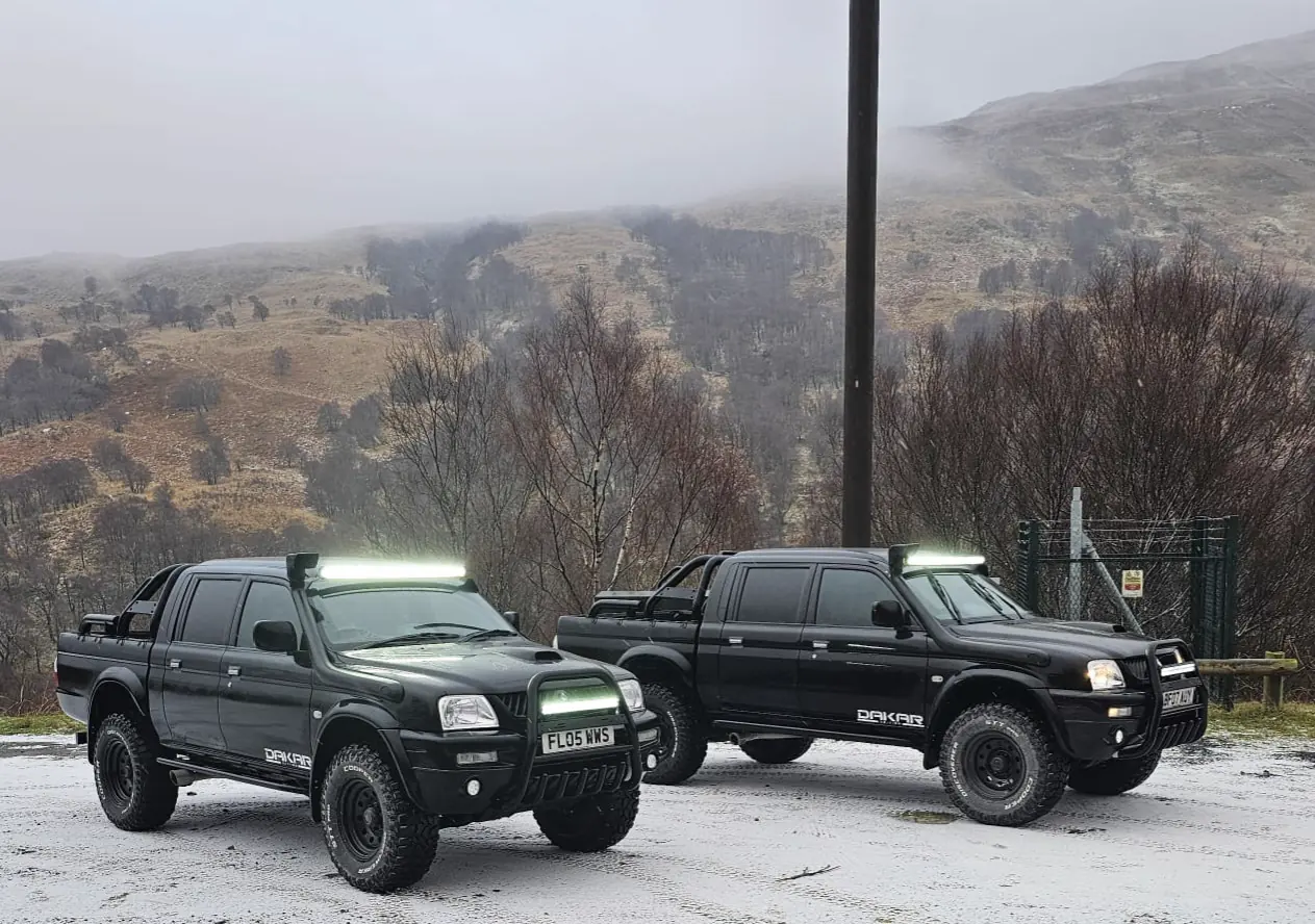 Jordan and Daniel’s two black Dakar Edition L200s side by side in the snow