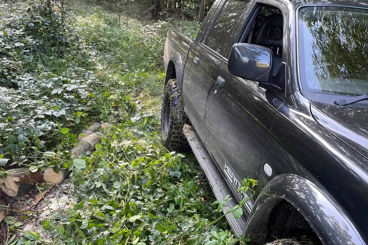 An owner&rsquo;s black Dakar Edition on a woodland track