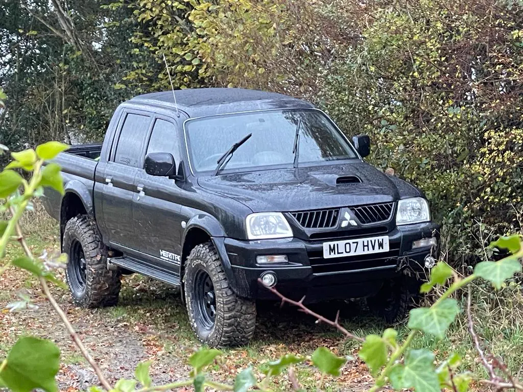 An owner&rsquo;s black Dakar Edition parked under trees