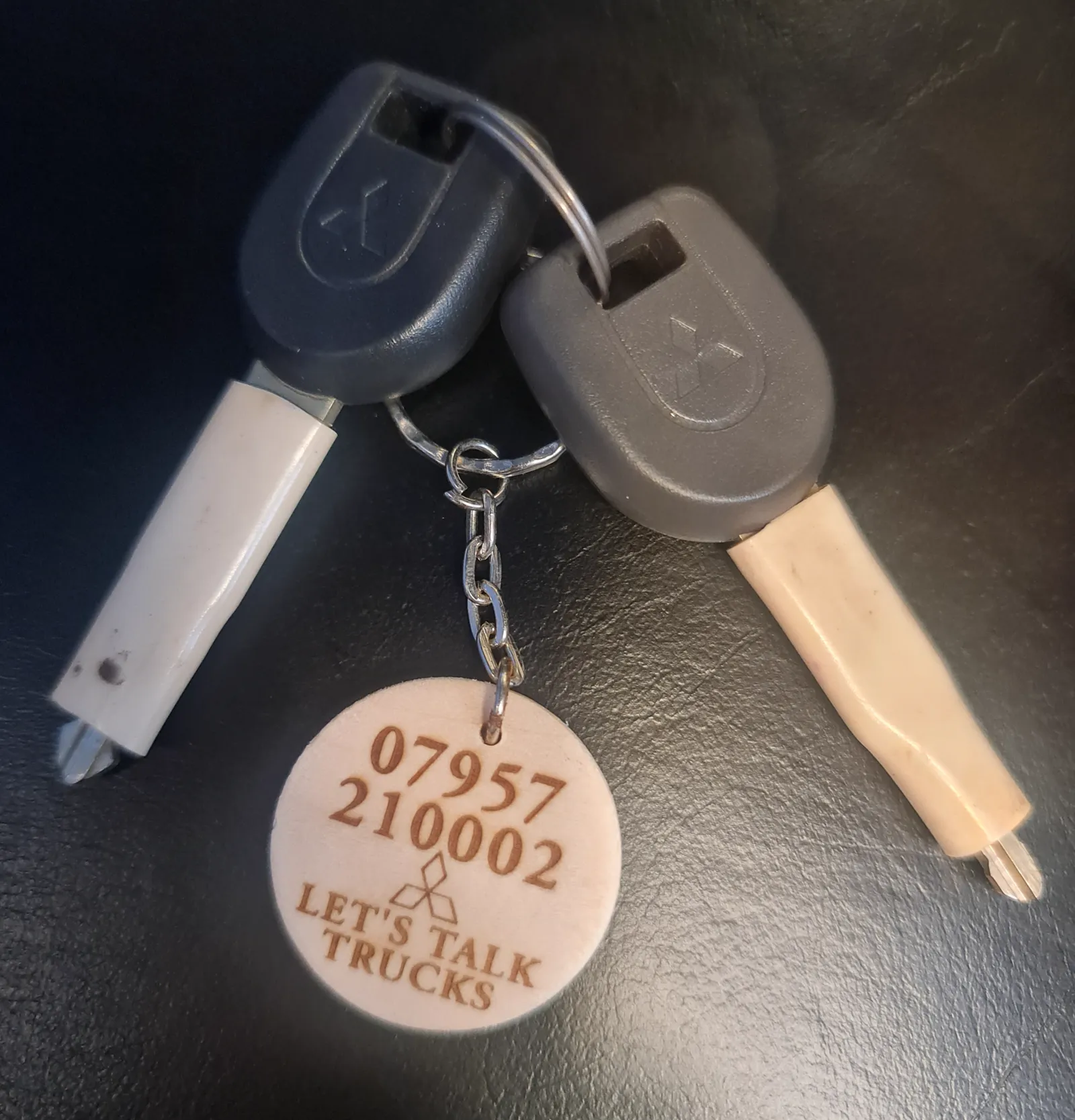 A set of Mitsubishi L200 keys with a Staffordshire Truck Company tag