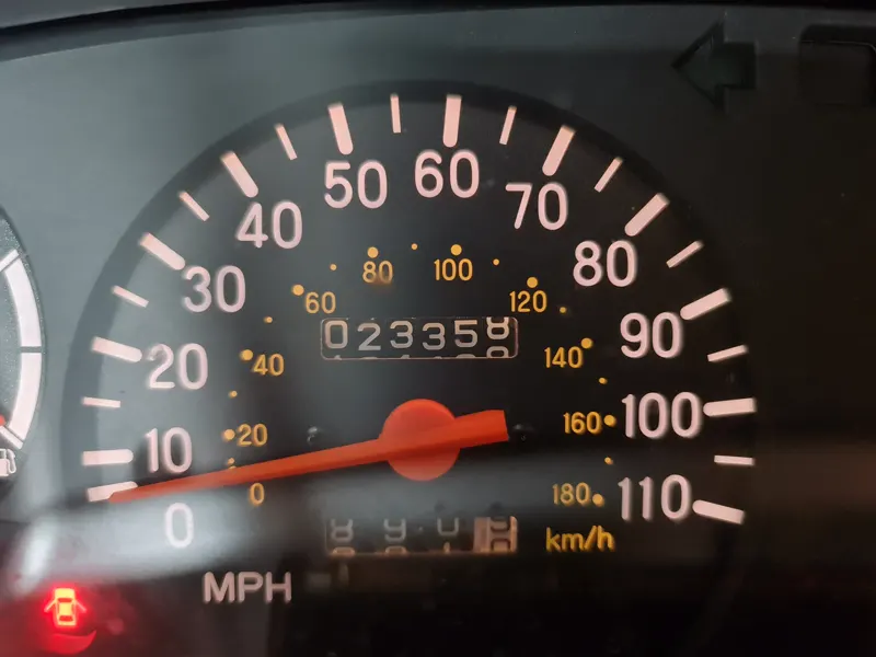 The speedometer of a Mitsubishi L200 K74 reading twenty-three thousand miles